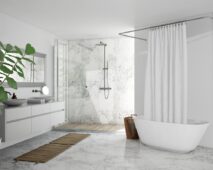 Luxury bathroom renovation in Melbourne featuring a modern spa-style bathroom with freestanding bathtub, marble tiles, frameless glass shower, and minimalist vanity design.